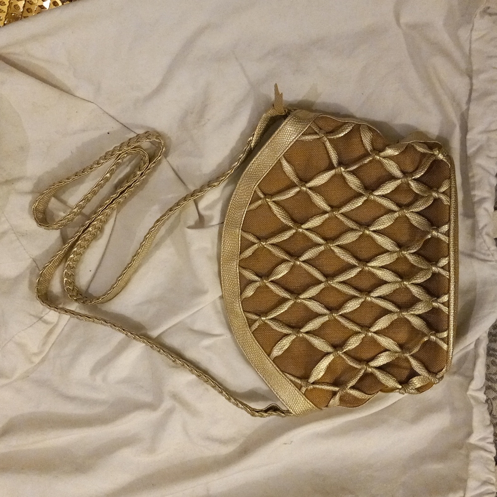 Gold Tiani handbag w/ braided strap and lattice design on sides